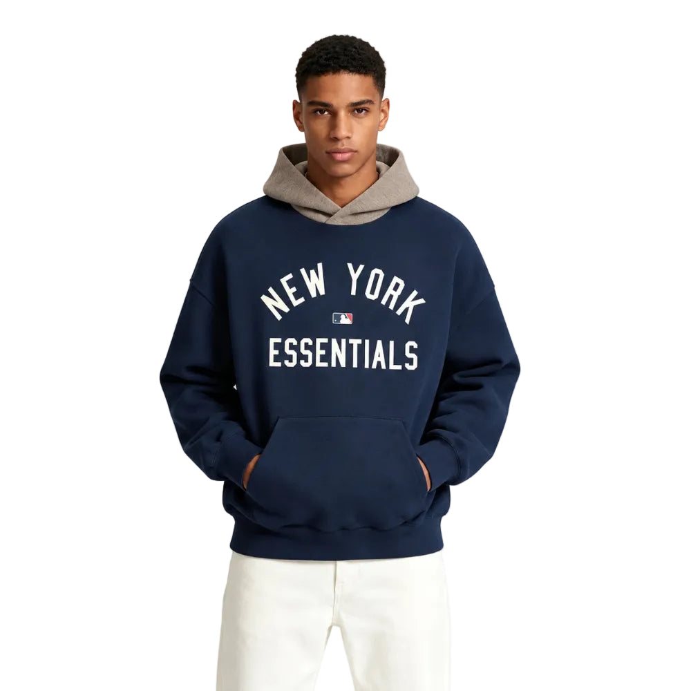 Fear of God Essentials Yankees Sport Hoodie Midnight Navy Homestead Heather worn by model from the front