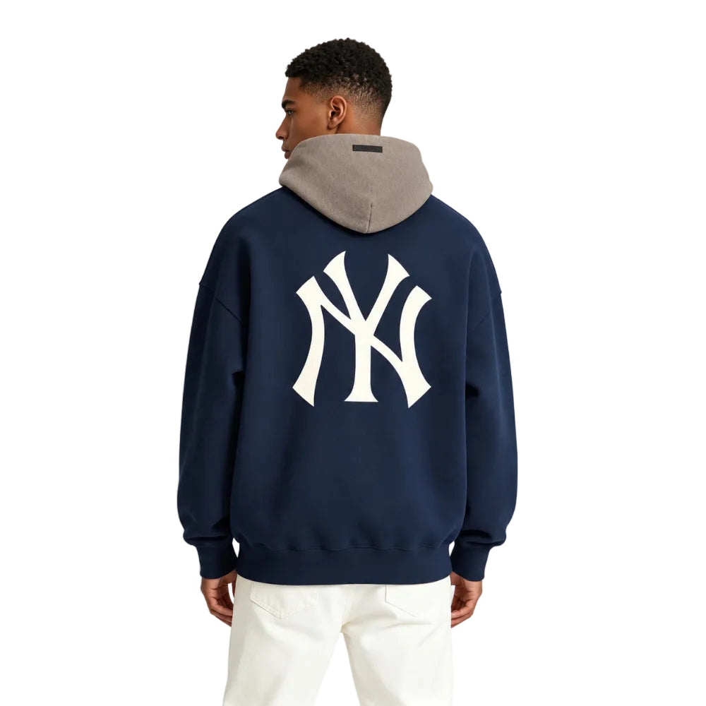 Fear of God Essentials Yankees Sport Hoodie Midnight Navy Homestead Heather shown on model from the back