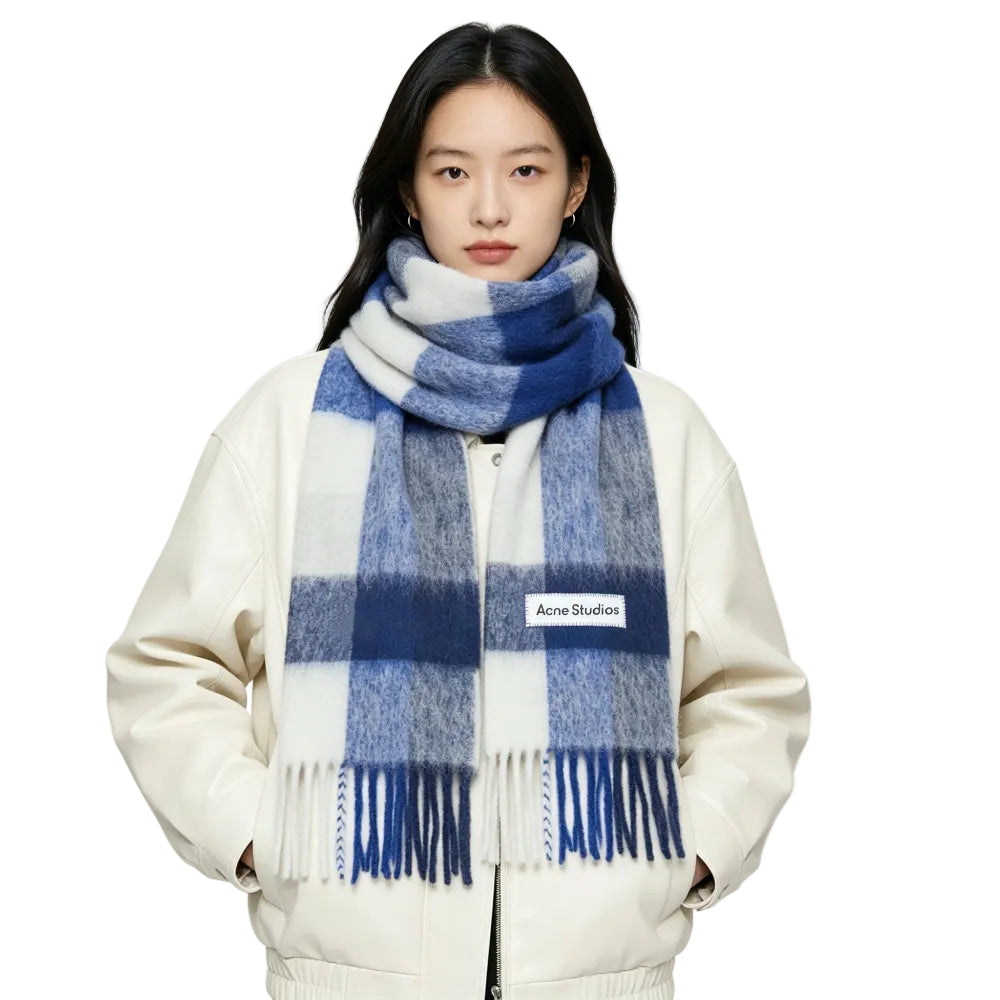 Model wearing Acne Studios Mohair Checked Scarf in White Grey Royal Blue – front view highlighting the colorful plaid pattern and fringed edges