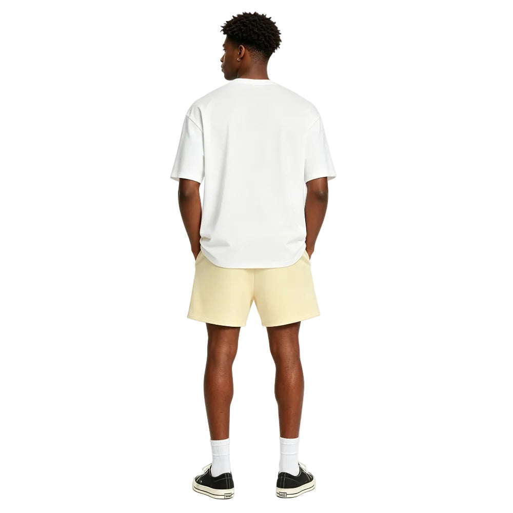 Fear of God Essentials Sweatshort Garden Yellow shown on model from the back