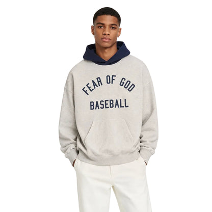 Fear of God Essentials MLB Sport Hoodie Oatmeal Heather Midnight Navy worn by model from the front