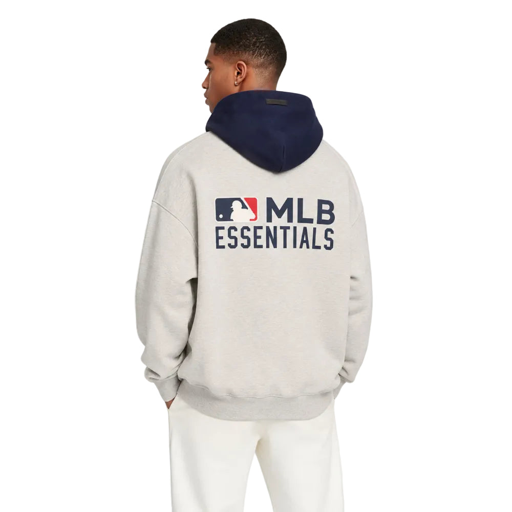 Fear of God Essentials MLB Sport Hoodie Oatmeal Heather Midnight Navy shown on model from the back