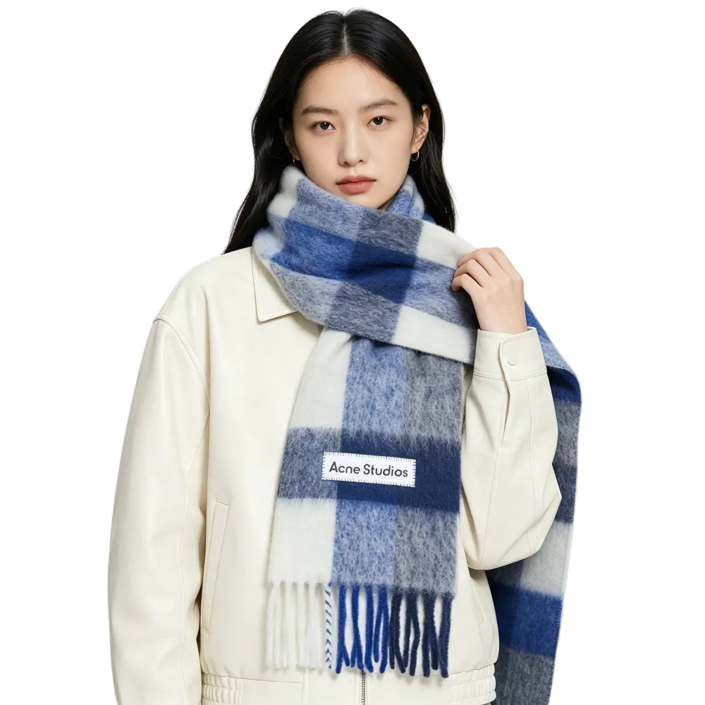 Model wearing Acne Studios Mohair Checked Scarf in White Grey Royal Blue – front view highlighting the colorful plaid pattern and fringed edges